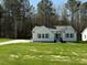 Charming single-story home featuring a well-manicured lawn and a concrete driveway at 325 Magnolia Run Way, Benson, NC 27504