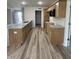 Kitchen featuring wood-look floors, wooden cabinets, and granite countertops at 325 Magnolia Run Way, Benson, NC 27504