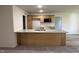 Kitchen featuring a breakfast bar, granite countertops, and wooden cabinets at 325 Magnolia Run Way, Benson, NC 27504