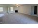 Spacious living room featuring a fireplace, windows, and carpet flooring at 325 Magnolia Run Way, Benson, NC 27504
