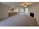 Bright open living space featuring a fireplace and views into the kitchen and breakfast bar at 325 Magnolia Run Way, Benson, NC 27504