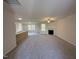 Open living space featuring a fireplace, ceiling fan, and views into the kitchen at 325 Magnolia Run Way, Benson, NC 27504