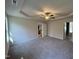 Spacious main bedroom featuring carpet floors, a tray ceiling, and a ceiling fan at 325 Magnolia Run Way, Benson, NC 27504