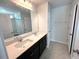 Elegant bathroom featuring double sinks, dark cabinets and a large mirror at 35 Calabria Ct, Franklinton, NC 27525
