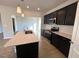 Kitchen view showcasing the island, stainless steel appliances, and dark cabinetry at 35 Calabria Ct, Franklinton, NC 27525