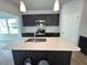 New kitchen features dark cabinets, an island with white countertop, and stainless steel appliances at 35 Calabria Ct, Franklinton, NC 27525