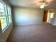 Bright living room featuring large windows, a fan and neutral walls at 35 Calabria Ct, Franklinton, NC 27525