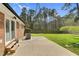 Backyard boasts a brick home, patio, green lawn, and privacy fence at 3910 Hillgrand Dr, Durham, NC 27705