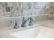 Close up of bathroom counter with stainless faucet over bright white basin at 3910 Hillgrand Dr, Durham, NC 27705