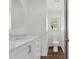 Bathroom boasts a marble countertop, dark hardwood-style floors, and a toilet near a window at 3910 Hillgrand Dr, Durham, NC 27705