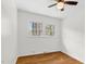 Bright bedroom features hardwood floors, white walls, and a ceiling fan at 3910 Hillgrand Dr, Durham, NC 27705