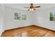 Bright bedroom with hardwood floors, ceiling fan, and large windows at 3910 Hillgrand Dr, Durham, NC 27705