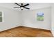 Bedroom with hardwood floors, ceiling fan, and plenty of natural light at 3910 Hillgrand Dr, Durham, NC 27705