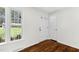 Bright entryway featuring hardwood floors, a window, and white trim and doors at 3910 Hillgrand Dr, Durham, NC 27705
