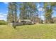Exterior view of a single-Gathering home with a large lawn and mature trees at 3910 Hillgrand Dr, Durham, NC 27705