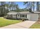 Beautiful single-story home with brick accents, a manicured lawn and attached garage at 3910 Hillgrand Dr, Durham, NC 27705