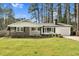 Beautiful single-story home with brick accents, a manicured lawn and attached garage at 3910 Hillgrand Dr, Durham, NC 27705