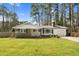 Beautiful single-story home with brick accents, a manicured lawn and attached garage at 3910 Hillgrand Dr, Durham, NC 27705