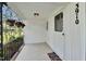 Charming front porch featuring hanging flower baskets, a white door and concrete floor at 3910 Hillgrand Dr, Durham, NC 27705