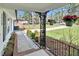 Cozy front porch with decorative iron railings, hanging flower pots, and a stone pathway at 3910 Hillgrand Dr, Durham, NC 27705
