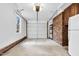 Well-lit garage featuring brick accents, concrete floors, with a convenient refrigerator at 3910 Hillgrand Dr, Durham, NC 27705