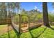 Wooden frame, partially enclosed, forming a garden bed with green grass at 3910 Hillgrand Dr, Durham, NC 27705