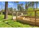Wooden frame, partially enclosed, forming a garden bed with green grass at 3910 Hillgrand Dr, Durham, NC 27705