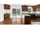 Open kitchen with granite countertops, wooden cabinets, and a view of the backyard at 3910 Hillgrand Dr, Durham, NC 27705