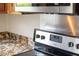 Close-up of Whirlpool stove and granite countertop in updated kitchen at 3910 Hillgrand Dr, Durham, NC 27705