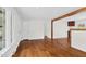 Open living area with hardwood floors, a large window, and entryways to other rooms at 3910 Hillgrand Dr, Durham, NC 27705