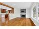 Open floor plan with hardwood floors, a fireplace, and a view into the updated kitchen at 3910 Hillgrand Dr, Durham, NC 27705