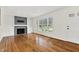 Spacious living room with hardwood floors, a fireplace with built-ins, and large windows at 3910 Hillgrand Dr, Durham, NC 27705