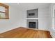 Bright living room featuring a grey brick fireplace and built-in shelves at 3910 Hillgrand Dr, Durham, NC 27705