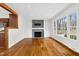 Open floor plan with a fireplace, hardwood floors, and a view of the kitchen at 3910 Hillgrand Dr, Durham, NC 27705