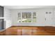Bright living room showcasing hardwood floors, built-ins, and a large picture window at 3910 Hillgrand Dr, Durham, NC 27705