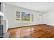 Living area features large window, hardwood flooring, and an entryway with a front door at 3910 Hillgrand Dr, Durham, NC 27705