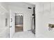 Clean utility room with marble floors, modern shelving, and a glimpse into the garage at 3910 Hillgrand Dr, Durham, NC 27705
