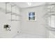 Bright walk-in closet with modern shelving, marble tile, and a window offering outdoor views at 3910 Hillgrand Dr, Durham, NC 27705