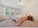Cozy bedroom with soft carpet, ample natural light from two windows, and neutral-colored bedding at 4070 Landover Ln, Raleigh, NC 27616