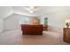 Spacious bonus room featuring carpet, a large wooden cabinet, a ceiling fan, and ample natural light at 4070 Landover Ln, Raleigh, NC 27616