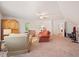 Expansive bonus room with neutral carpet, a ceiling fan, and a seating area with two sofas at 4070 Landover Ln, Raleigh, NC 27616