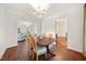 Spacious dining room with wood floors leading into a view of the living room and kitchen at 4070 Landover Ln, Raleigh, NC 27616