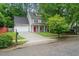 Inviting two-story home with a bright red front door and attached two car garage at 4070 Landover Ln, Raleigh, NC 27616