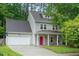 Charming two-story home with a red front door, attached garage and a well-manicured lawn at 4070 Landover Ln, Raleigh, NC 27616