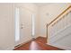 Inviting foyer with hardwood floors, a staircase, a white door, and a sidelight window at 4070 Landover Ln, Raleigh, NC 27616