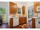 Functional kitchen featuring wood cabinets, tiled backsplash, and a stainless steel sink at 4070 Landover Ln, Raleigh, NC 27616