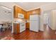 Efficient kitchen with white appliances, wooden cabinets, and a view of the dining area at 4070 Landover Ln, Raleigh, NC 27616