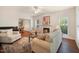 Bright living room with a fireplace, plush seating, large windows and neutral color palette at 4070 Landover Ln, Raleigh, NC 27616