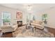 Cozy living room featuring a fireplace, comfortable seating, and natural light from large windows at 4070 Landover Ln, Raleigh, NC 27616