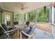 Cozy screened porch features a seating area and a view of the backyard, offering a serene outdoor space at 4070 Landover Ln, Raleigh, NC 27616